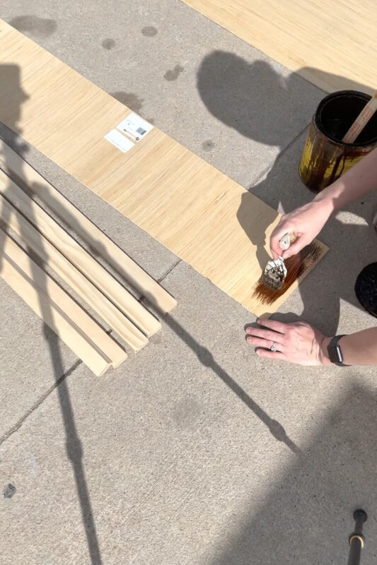 Applying stain to a board.